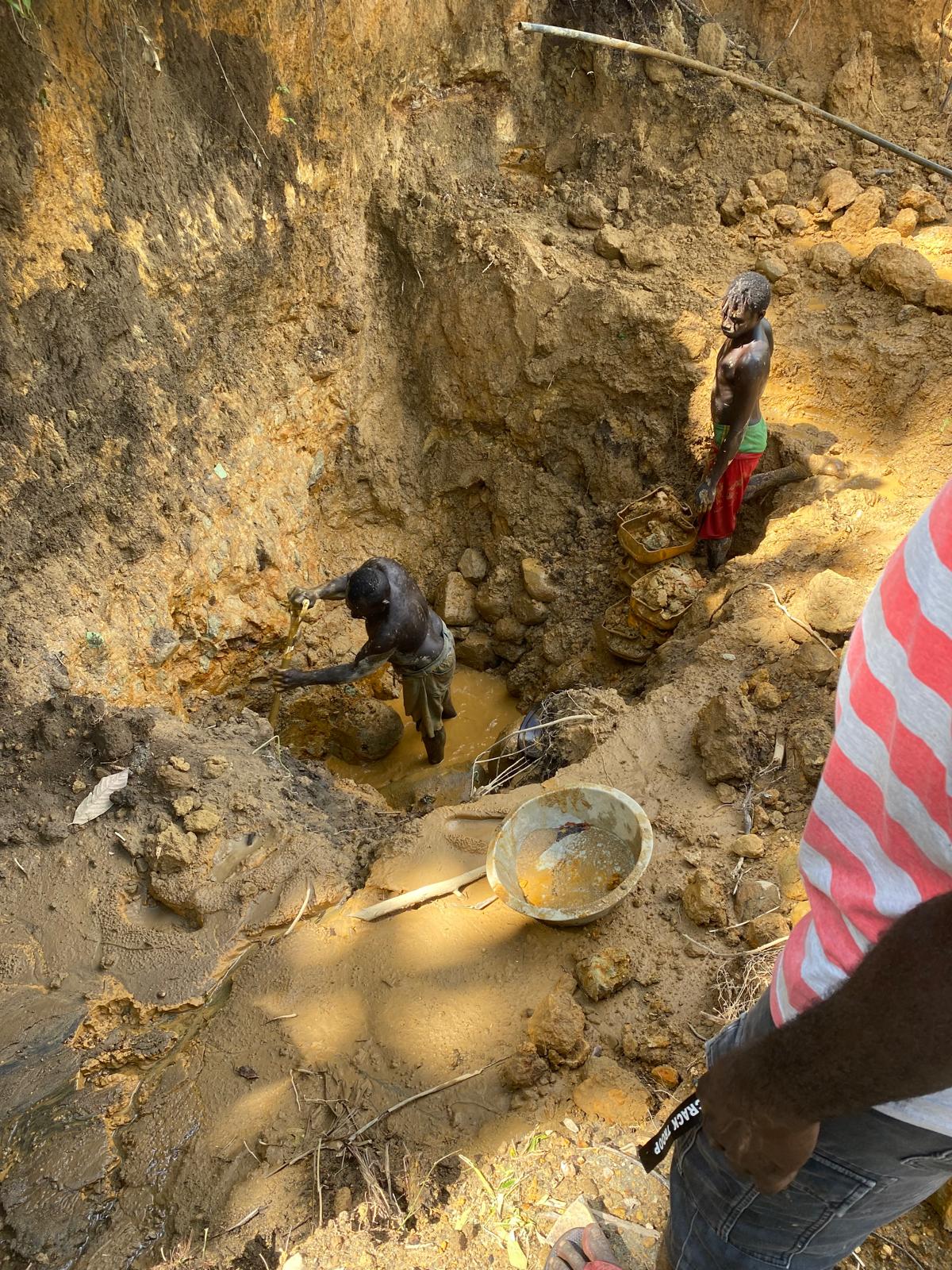 Workers extracting gold-bearing material by hand from the near-surface clay pit in Bougainville
